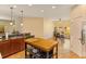 Kitchen with stainless steel appliances, kitchen island, granite countertops, and attached dining area at 3783 Moon Dancer Pl, St Cloud, FL 34772
