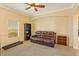 Comfortable living room with a plush brown leather sofa, bright windows, and neutral decor at 3783 Moon Dancer Pl, St Cloud, FL 34772