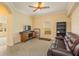 Cozy living room featuring plush carpeting, a ceiling fan, and a comfortable leather sofa at 3783 Moon Dancer Pl, St Cloud, FL 34772
