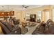 Spacious living room with plush leather seating, a large rug, and an open layout at 3783 Moon Dancer Pl, St Cloud, FL 34772