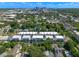 Aerial view of modern townhome community, surrounded by lush trees and the distant city skyline at 38 W Harding St # C, Orlando, FL 32806