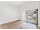Minimalist bedroom featuring hardwood floors and large window offering lots of natural light at 38 W Harding St # C, Orlando, FL 32806