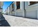 Row of modern townhomes with white garage doors and paver driveway at 38 W Harding St # C, Orlando, FL 32806