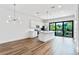 Bright, open-concept kitchen with modern white cabinets, stainless steel appliances, and island overlooking the living area at 38 W Harding St # C, Orlando, FL 32806