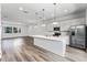 Eat-in kitchen features a center island, stainless appliances, and modern lighting at 38 W Harding St # C, Orlando, FL 32806