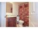 Bathroom with an ornate, carved wood vanity and patterned shower curtain at 4161 Versailles Dr # 4161G, Orlando, FL 32808