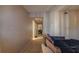 A hallway leading to a bedroom with light walls with a sofa visible at 4161 Versailles Dr # 4161G, Orlando, FL 32808