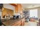 Kitchen featuring granite countertops, wood cabinets, and tile flooring, offering ample storage at 4161 Versailles Dr # 4161G, Orlando, FL 32808