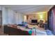 Open-concept living room with tile flooring and a view into the dining area at 4161 Versailles Dr # 4161G, Orlando, FL 32808
