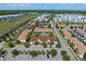 Wide aerial view of the community showcasing the residential layout, nearby roads, and surrounding nature at 4895 Clock Tower Dr, Kissimmee, FL 34746