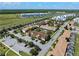 Wide aerial view of the community showing streets, landscaping, parking and the surrounding neighborhood at 4895 Clock Tower Dr, Kissimmee, FL 34746