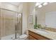 Modern bathroom with a tiled walk-in shower, granite vanity top, and stylish fixtures at 4895 Clock Tower Dr, Kissimmee, FL 34746