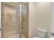 Bathroom showcases a tiled walk-in shower with a glass door and modern fixtures at 4895 Clock Tower Dr, Kissimmee, FL 34746