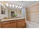 Bright bathroom featuring a double vanity with granite countertops and a shower-tub combo at 4895 Clock Tower Dr, Kissimmee, FL 34746