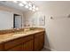 Bathroom featuring a granite countertop vanity with double sinks and modern lighting fixtures at 4895 Clock Tower Dr, Kissimmee, FL 34746