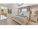 Bedroom featuring a white bed frame with a view into the attached bathroom and 'LOVE' wall art at 4895 Clock Tower Dr, Kissimmee, FL 34746