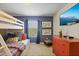 Charming bedroom featuring a cozy bunk bed with a full-sized bed on the bottom and twin on the top at 4895 Clock Tower Dr, Kissimmee, FL 34746