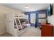 Charming bedroom featuring a cozy bunk bed with a full-sized bed on the bottom and twin on the top at 4895 Clock Tower Dr, Kissimmee, FL 34746