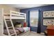 Charming bedroom featuring a cozy bunk bed with a full-sized bed on the bottom and twin on the top at 4895 Clock Tower Dr, Kissimmee, FL 34746