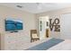 Bedroom features a television, dresser, and view into the attached bathroom for added convenience and comfort at 4895 Clock Tower Dr, Kissimmee, FL 34746