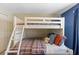 Charming bedroom featuring a cozy bunk bed with a full-sized bed on the bottom and twin on the top at 4895 Clock Tower Dr, Kissimmee, FL 34746