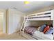 Charming bedroom featuring a cozy bunk bed with a full-sized bed on the bottom and twin on the top at 4895 Clock Tower Dr, Kissimmee, FL 34746