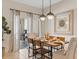 Charming dining area with stylish lighting, seating for four, and access to the outdoor patio at 4895 Clock Tower Dr, Kissimmee, FL 34746
