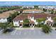 Low aerial view showcasing the community's well-maintained landscaping and ample parking at 4895 Clock Tower Dr, Kissimmee, FL 34746