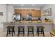 Well-equipped kitchen featuring a breakfast bar with comfortable seating and granite countertops for food preparation at 4895 Clock Tower Dr, Kissimmee, FL 34746