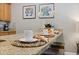 Inviting kitchen features a granite countertop, casual seating, and an elegant arrangement of decorative place settings at 4895 Clock Tower Dr, Kissimmee, FL 34746