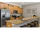 Well-appointed kitchen with stainless steel appliances, granite countertops, and convenient breakfast bar seating at 4895 Clock Tower Dr, Kissimmee, FL 34746