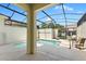 Inviting screened-in pool area with lounge chairs, perfect for relaxation and entertainment at 4895 Clock Tower Dr, Kissimmee, FL 34746