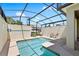 Screened-in pool with patio chairs, and privacy walls at 4895 Clock Tower Dr, Kissimmee, FL 34746