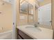 Close up view of a half bathroom featuring vanity with modern faucet and large mirror at 5252 Hidden Cypress Ln, Oviedo, FL 32765
