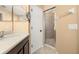 Bathroom vanity with light counters, a sink and a large mirror at 5252 Hidden Cypress Ln, Oviedo, FL 32765