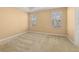 Bright bedroom with natural light coming through two windows and plush carpet at 5252 Hidden Cypress Ln, Oviedo, FL 32765