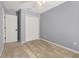 A well-lit bedroom featuring neutral gray walls, plush carpet, and a spacious double-door closet at 5252 Hidden Cypress Ln, Oviedo, FL 32765