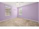Bedroom with neutral carpet, painted purple with two large windows for natural light at 5252 Hidden Cypress Ln, Oviedo, FL 32765