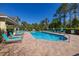 Sparkling community pool offering lounge chairs, umbrella tables, and a covered pavilion at 5252 Hidden Cypress Ln, Oviedo, FL 32765