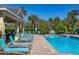 Community pool featuring crystal clear water, a covered pavilion, and plenty of lounge chairs at 5252 Hidden Cypress Ln, Oviedo, FL 32765