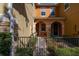 Inviting front entrance with arched doorway, wrought iron gate, and well-maintained landscaping at 5252 Hidden Cypress Ln, Oviedo, FL 32765