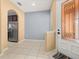 Welcoming entryway with tile floors, decorative glass front door, and view into the adjacent kitchen at 5252 Hidden Cypress Ln, Oviedo, FL 32765