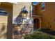 Close-up of the house number and stone accent wall with lantern creating a warm, inviting entrance at 5252 Hidden Cypress Ln, Oviedo, FL 32765