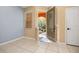 Bright foyer with neutral tile flooring, arched doorway, and view of the landscaped front yard at 5252 Hidden Cypress Ln, Oviedo, FL 32765