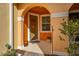 Charming front porch with decorative door, accent window, and potted plants, creating a welcoming space at 5252 Hidden Cypress Ln, Oviedo, FL 32765