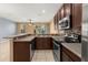 Features a granite counter, stainless appliances, open floor plan, and tile flooring at 5252 Hidden Cypress Ln, Oviedo, FL 32765