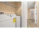 A laundry room with a washer and dryer and white shelves at 5252 Hidden Cypress Ln, Oviedo, FL 32765