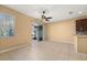 Living room featuring a ceiling fan, tile flooring, sliding glass doors to the patio and backyard at 5252 Hidden Cypress Ln, Oviedo, FL 32765