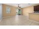 Living room with tile flooring, ceiling fan, sliding doors leading to patio, and kitchen bar top at 5252 Hidden Cypress Ln, Oviedo, FL 32765