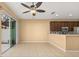 Open living area with tile floors, ceiling fan, and sliding glass doors to outdoor living space at 5252 Hidden Cypress Ln, Oviedo, FL 32765